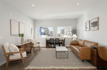 The living room of an apartment with a couch and a table